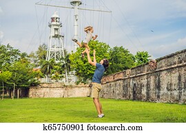 Dad and son on background of Fort Cornwallis in Georgetown, Penang, is a star fort built by the British East India Company in the late 18th century, it is the largest standing fort in Malaysia. Traveling with children concept