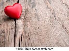Red heart in crack of wooden plank Red heart in crack of wooden plank
