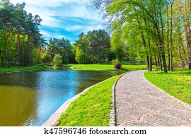 Summer scenery of the park alley with lake Summer scenery of the park alley with lake