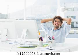 Relaxed casual business man with computer in bright office