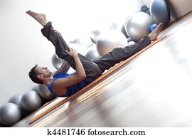 fusion of mind and body - man practicing pilates