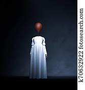Headless ghost woman in white with red balloon Headless ghost woman in white with red balloon