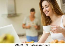 Woman using her laptop at breakfast