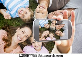 Composite image of hand holding smartphone showing Composite image of hand holding smartphone showing