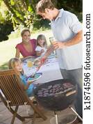 Family Enjoying A Barbeque Family Enjoying A Barbeque