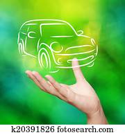Hand with car against green nature sky background as concept Hand with car against green nature sky background as concept