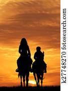 mother and child on horse at sunset mother and child on horse at sunset