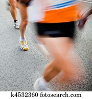 People running in city marathon - motion blur