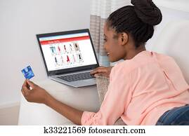 Woman With Debit Card Shopping Online