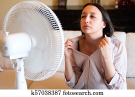 Woman feeling hot and trying to refresh in summertime heat