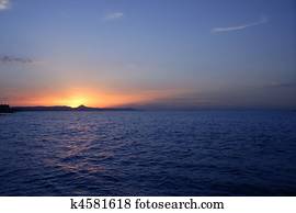 Beautiful sunset sunrise over blue sea ocean red sun sky