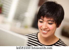Pretty Smiling Multiethnic Woman Using Laptop