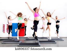 group of women doing aerobics on stepper group of women doing aerobics on stepper