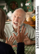 Senior couple at home focusing on angry man