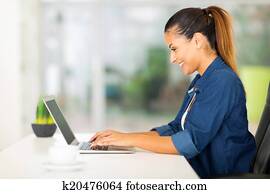 cheerful woman using laptop computer cheerful woman using laptop computer