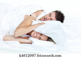 Couple in bed while the woman is trying to sleep 