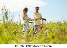 happy couple with bicycles at country happy couple with bicycles at country