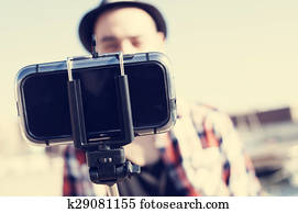 young man taking a selfie with a monopod