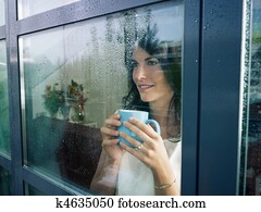woman staring at the window