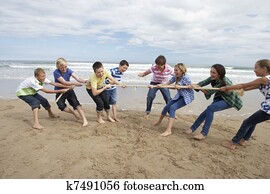 Teenagers playing tug of war