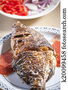Baked tilapia served with red pepper sauce