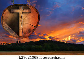 Wooden Cross on Tree Trunk at the Sunset