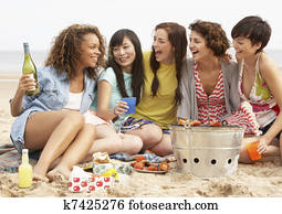 Group Of Girls Enjoying Barbeque On Beach Together Group Of Girls Enjoying Barbeque On Beach Together