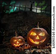 Halloween pumpkins on rocks at night Halloween pumpkins on rocks at night
