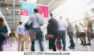 crowd of business people walking at a trade fair crowd of business people walking at a trade fair