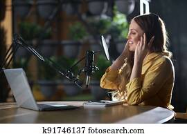 Woman recording interesting information for listeners.