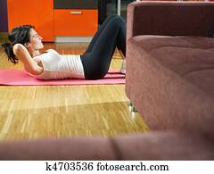 woman doing abs exercise at home