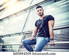 One handsome young man in city setting