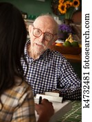 Elderly man in home with care provider or survey taker Elderly man in home with care provider or survey taker