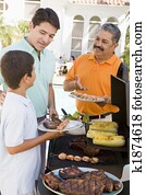 Family Enjoying A Barbeque Family Enjoying A Barbeque