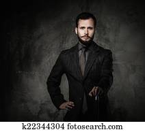 Handsome well-dressed man with stick 