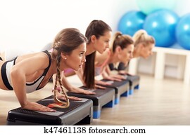 Group of smiling people doing push-ups Group of smiling people doing push-ups