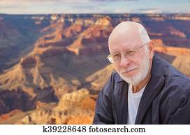 Happy Senior Man Posing on Edge of The Grand Canyon Happy Senior Man Posing on Edge of The Grand Canyon