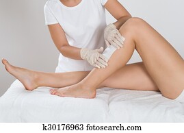 Beautician Waxing Leg Of Woman Beautician Waxing Leg Of Woman