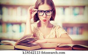 funny girl student with glasses reading books funny girl student with glasses reading books