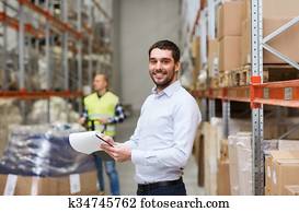 happy businessman with clipboard at warehouse happy businessman with clipboard at warehouse