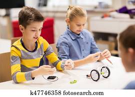 happy children building robots at robotics school happy children building robots at robotics school