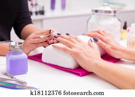 Nails saloon woman nail polish remove with tissue Nails saloon woman nail polish remove with tissue