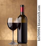 A bottle of red wine and filled a wine glass A bottle of red wine and filled a wine glass