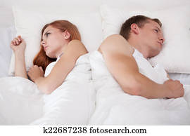Couple lying back to back
