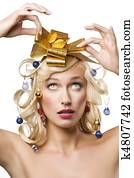 blond woman with a golden bow