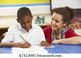 Schoolboy Studying In Classroom With Teacher Schoolboy Studying In Classroom With Teacher