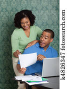 Young couple discussing their home budget at table