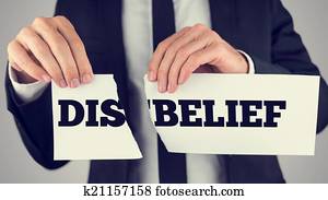 Man holding torn paper with the words Dis-Belief