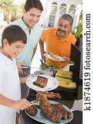 Family Enjoying A Barbeque Family Enjoying A Barbeque