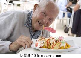 Old senior man with sundae